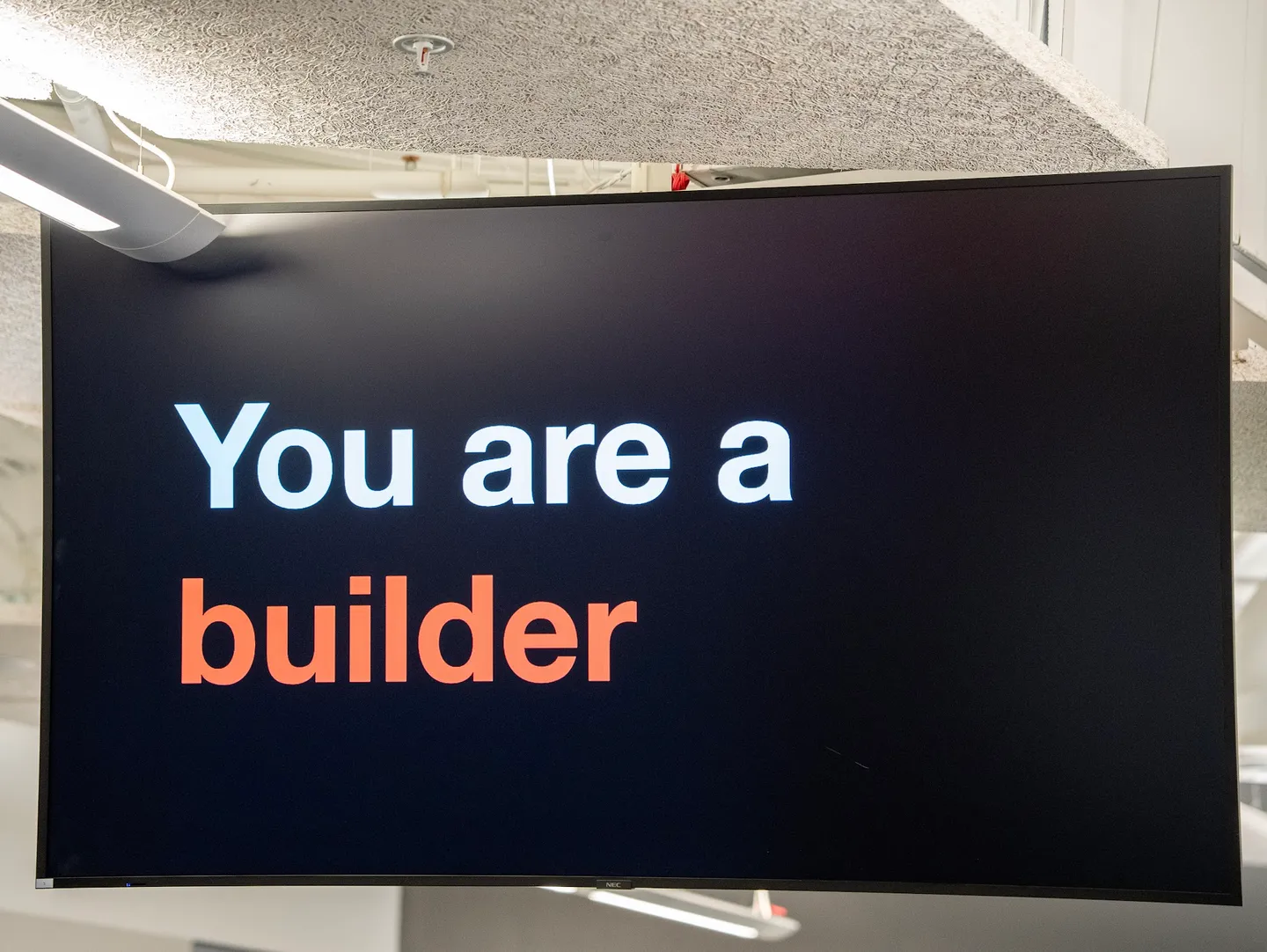 A screen at the hackathon displaying the message “You are a builder”